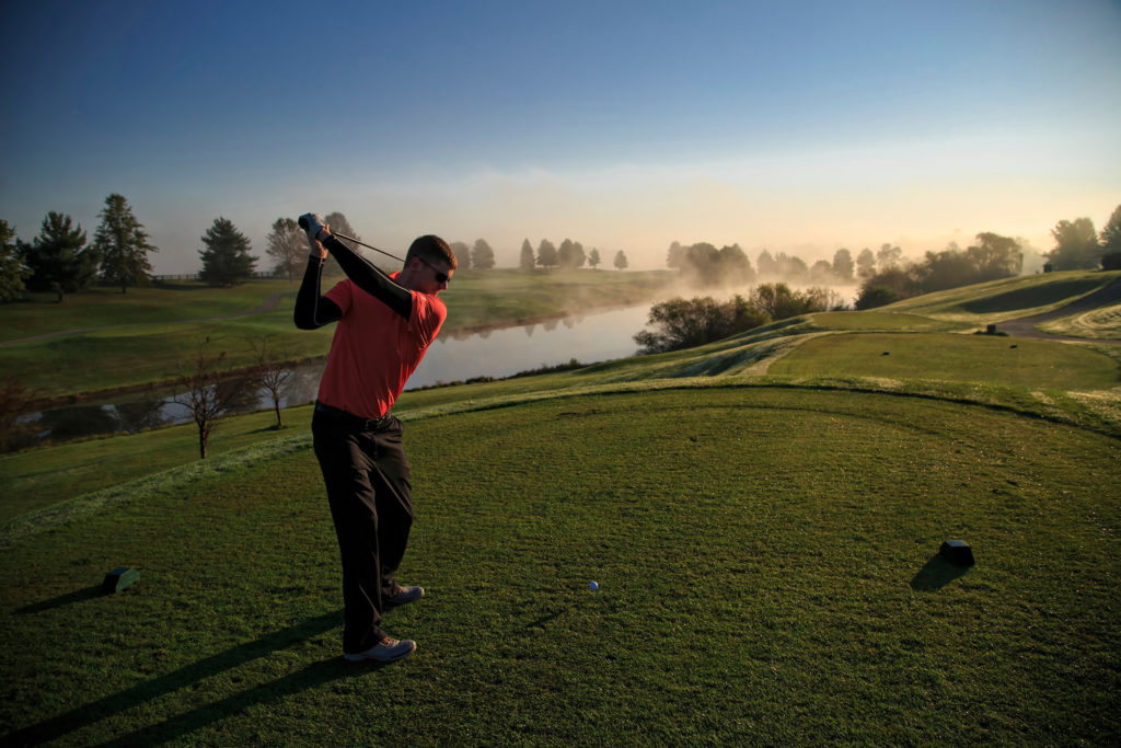 Golfer taking a swing at Gibson Bay Golf Course