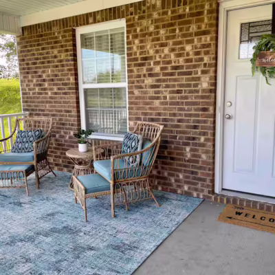 Exterior of short-term rental featuring outdoor seating and table