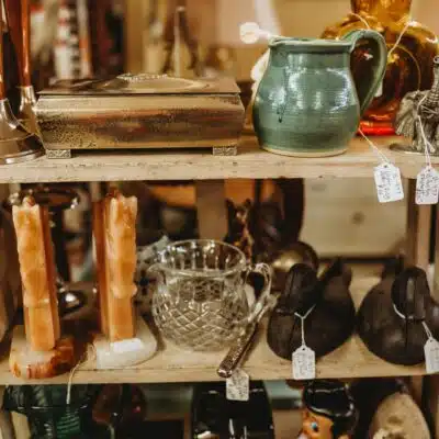 Selection of antiques on a display shelf at Peddlers Mall