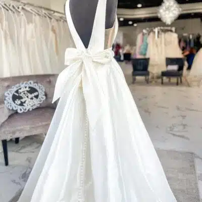 Wedding dress with plunging back with bow detail at Vivi's