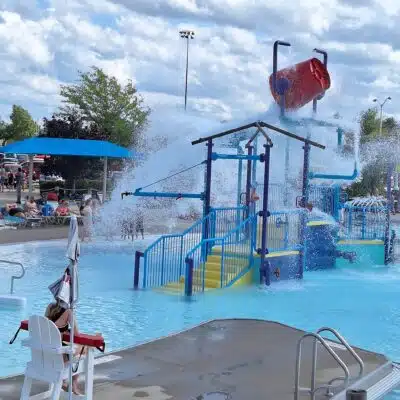 Lifeguard on duty and bucket of water dumping into pool