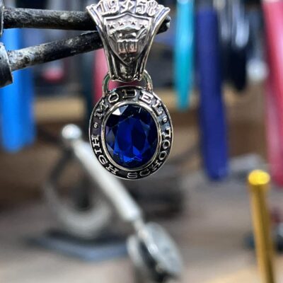 Closeup of a necklace pendant created from a class ring belong to someone's grandfather