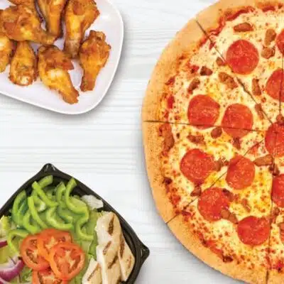 Pepperoni pizza, chicken wings, and salad from Snappy Tomato