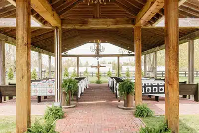 Outdoor ceremony at I Do at the Barn with the Cross at the altar