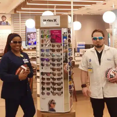Vision center employees holding sports equipment
