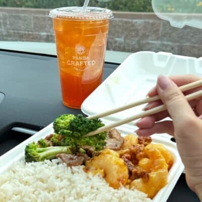 To-go box from Panda Express being eaten with chopsticks with a crafted drink