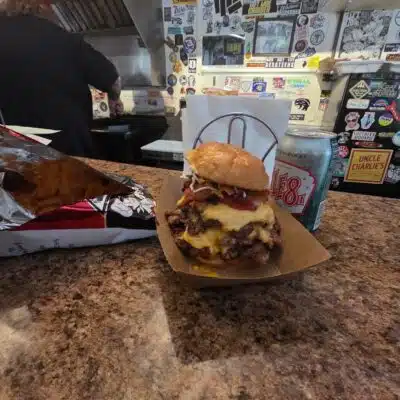 Stacked cheeseburger on counter of Wink's Bar