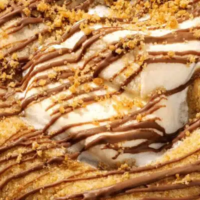 Crumbl cookie with drizzle and crumb coating