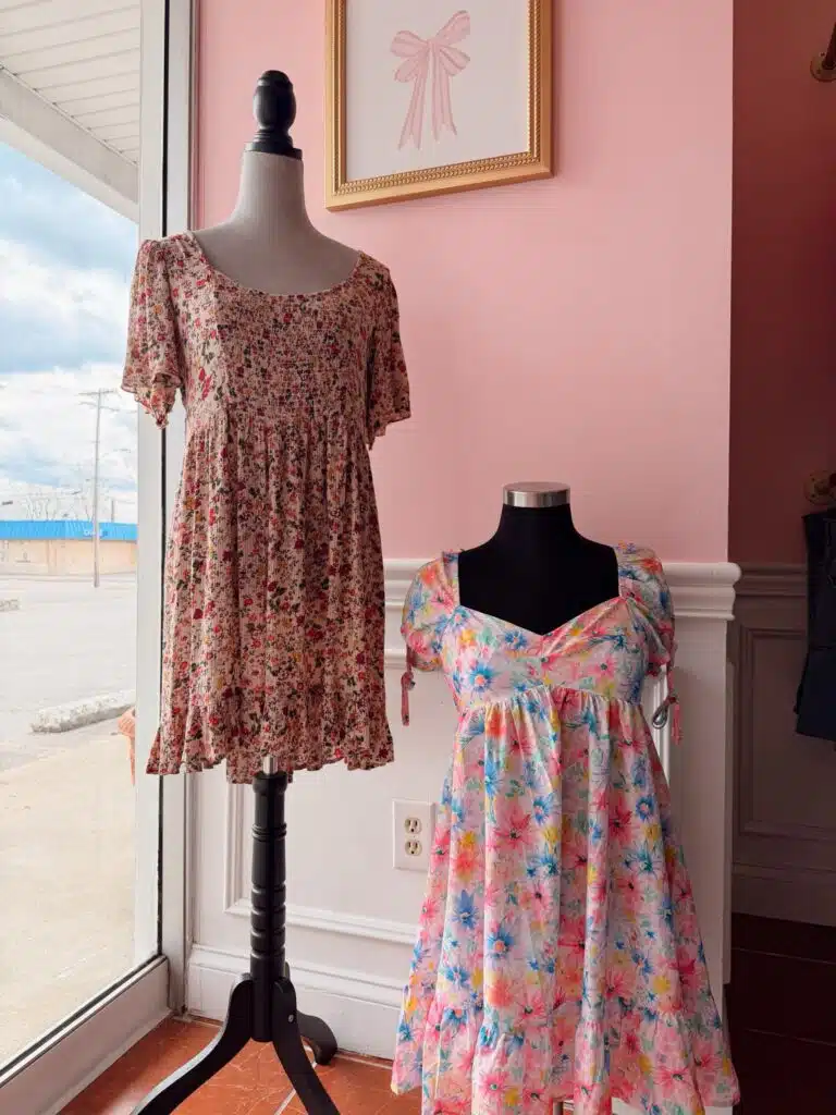Two floral dresses on mannequins inside Summer Lynn's Consignment