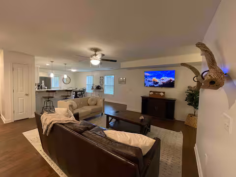 Living room of short-term rental featuring leather furniture and a smart TV