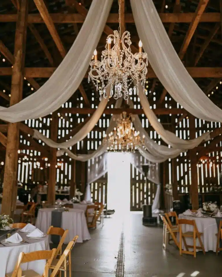 Chandeliers and draperies inside the barn space at Chenault Vineyards