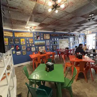 Interior of Islands in the Stream featuring the bright tables and chairs
