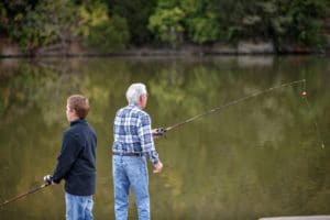 Grandfather and grandson fishing together at Lake Reba