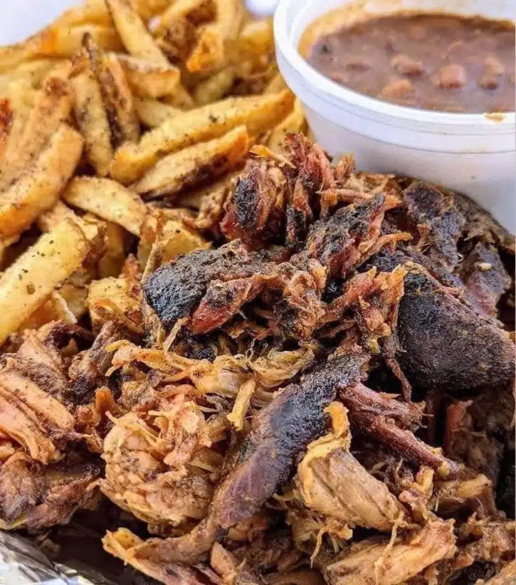 Potato wedges, beans, and mean on platter