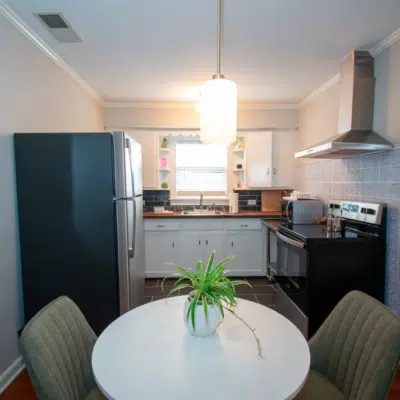Dining table and kitchen inside Westfield Gold (Airbnb)