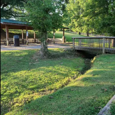 Grass and bridge connecting paved path to the shelter at E.C. Million Park