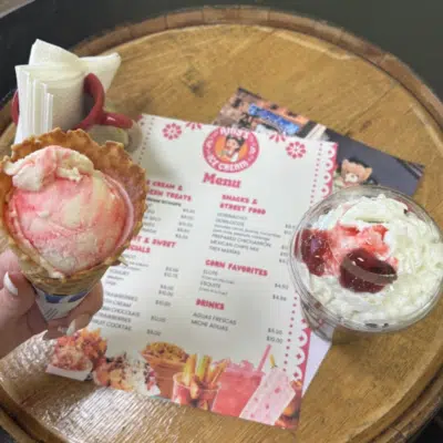Aerial view of Amy's Ice Cream menu, strawberry and cream cone, and Dutch Chocolate shake.