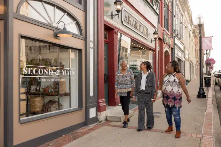 Trio of family members walking in front of Second & Main and Apparitions Vintage Village in downtown Richmond