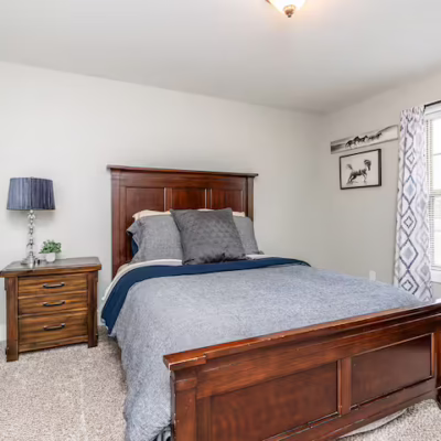 Primary bedroom of short-term rental, showcasing the older style headboard and footboard