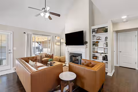 Living room of short-term rental featuring faux leather furnishings
