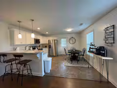 Open concept of dining space, kitchen, and living room
