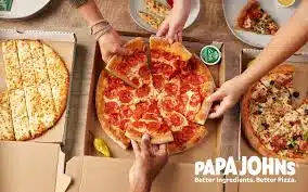 Aerial view of hands pulling apart a pepperoni pizza from Papa John's