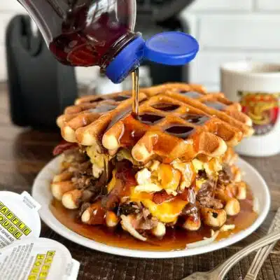 Syrup pouring onto stack of waffles from Waffle House